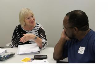 Two people sitting at a table meeting