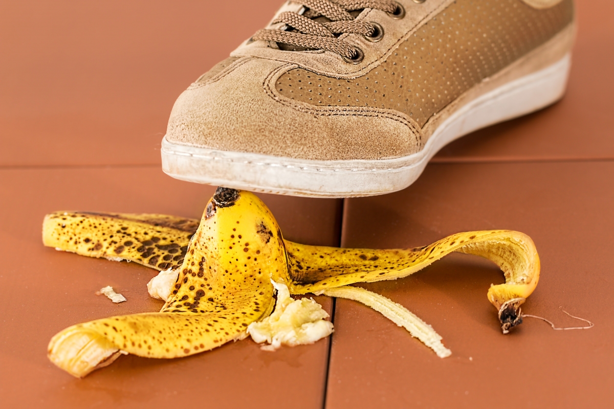 Foot of someone about to step on a banana peal