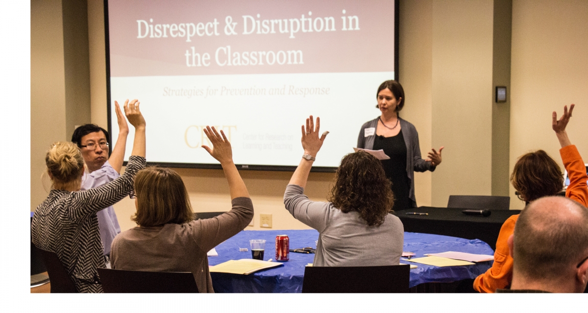 Students in class with hands raised