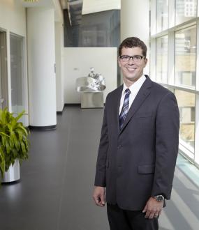 A photo of Robbie Moon, standing inside of the Scheller College of Business.